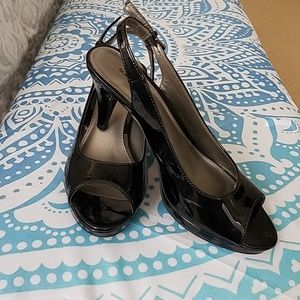 Shiny black open toe sling backs.